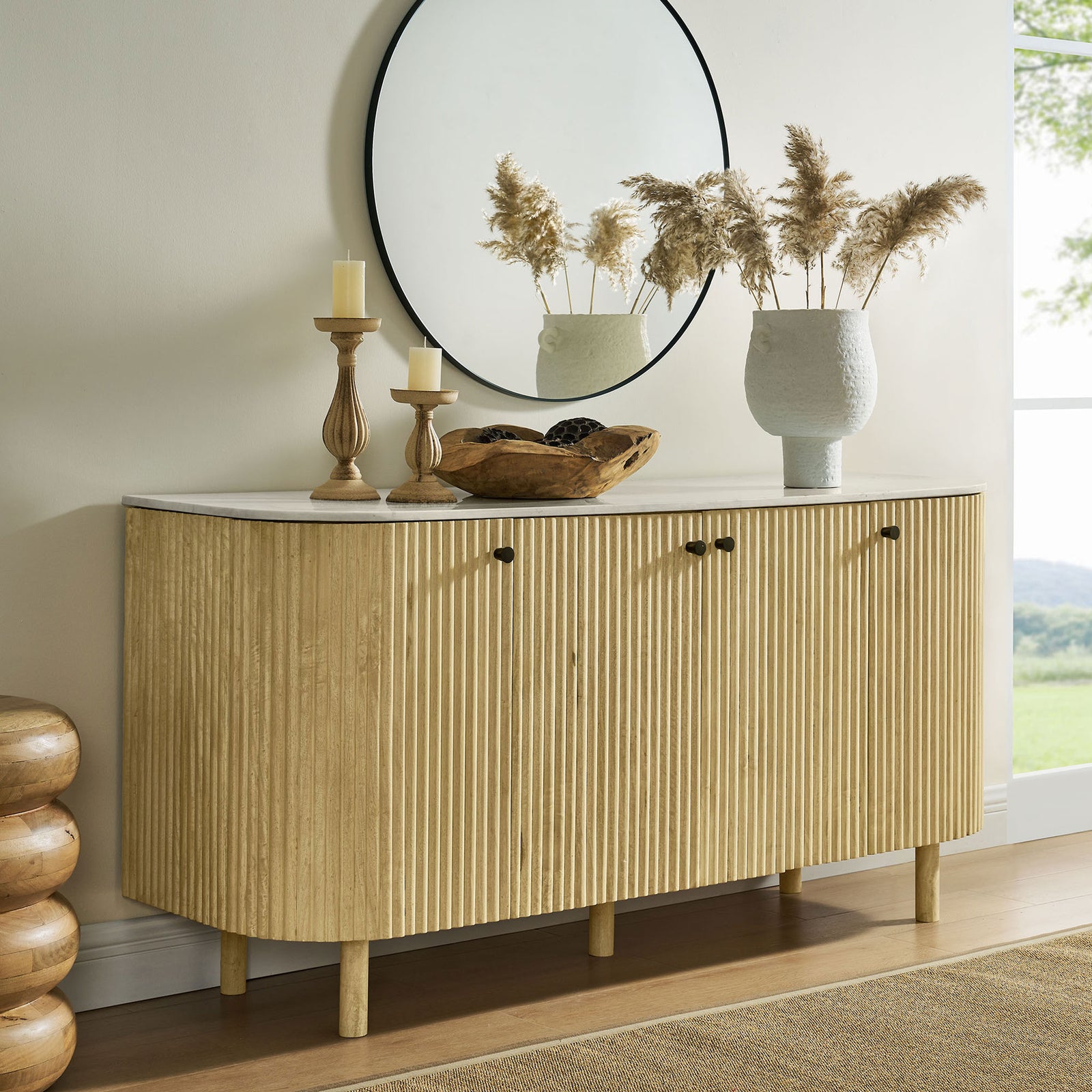 Natural wood sideboard with marble top styled with decor in a contemporary living room || EEI-7355-NAT || front_angle_room
