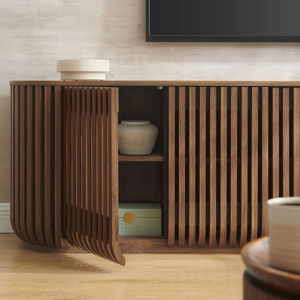 Open cabinet door reveals styled shelves for decor and storage, set against a warm modern living room backdrop || EEI-7359-WAL || storage_open_room