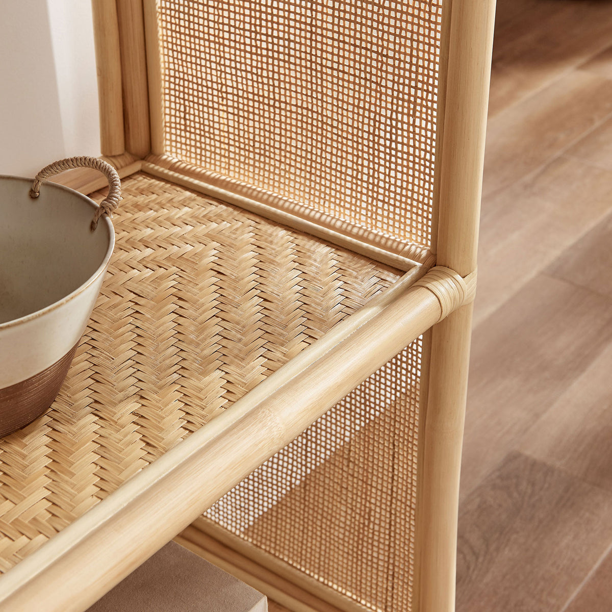 Textured rattan shelving adds warmth and airy charm to styled decor in the living space. || EEI-7363-NAT || detail_room