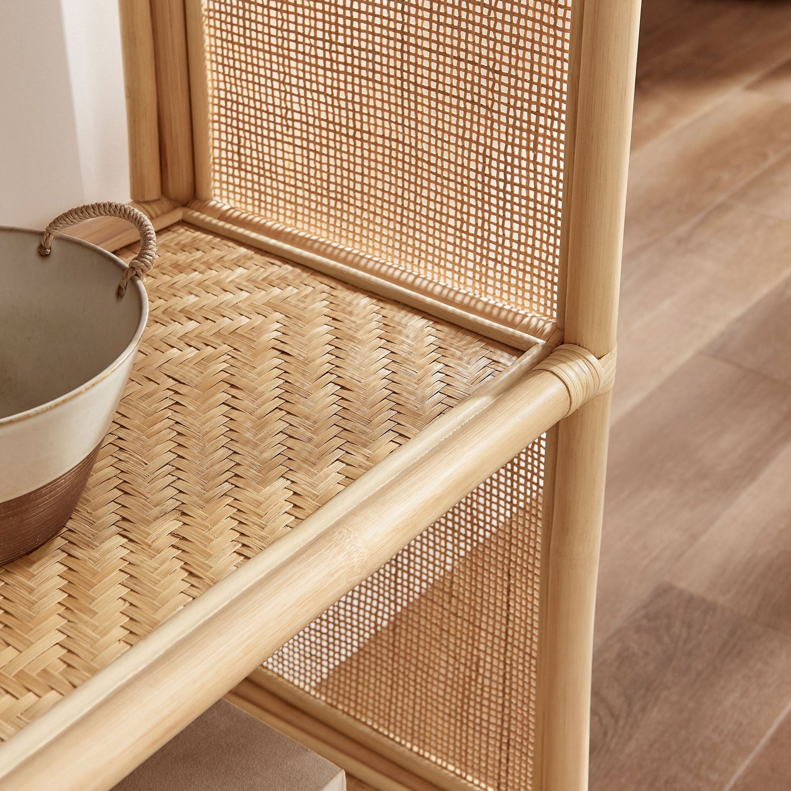 Textured rattan shelving adds warmth and airy charm to styled decor in the living space. || EEI-7363-NAT || detail_room