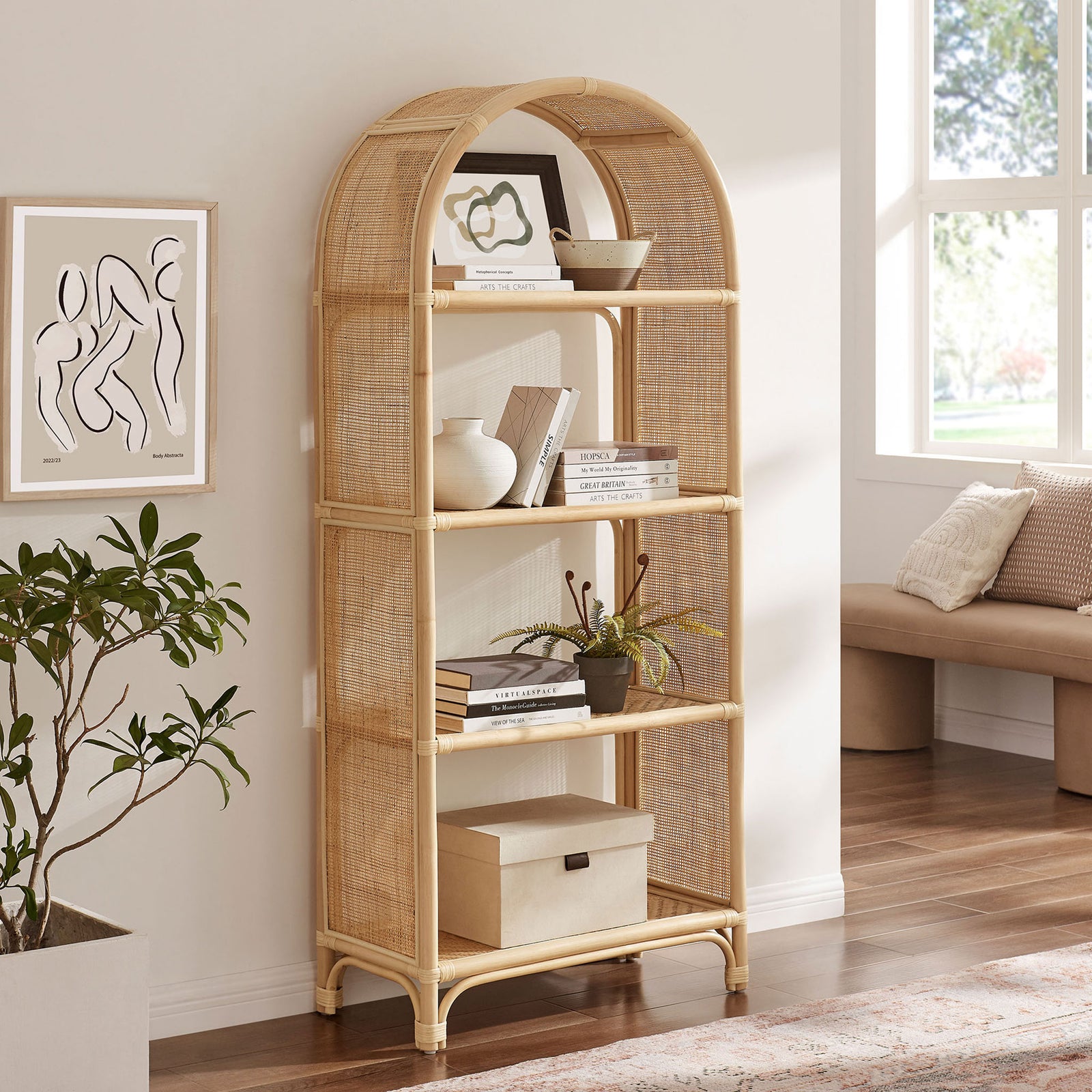 Tall arched rattan bookcase brings organic warmth and open shelving to a modern room. || EEI-7363-NAT || front_angle_room