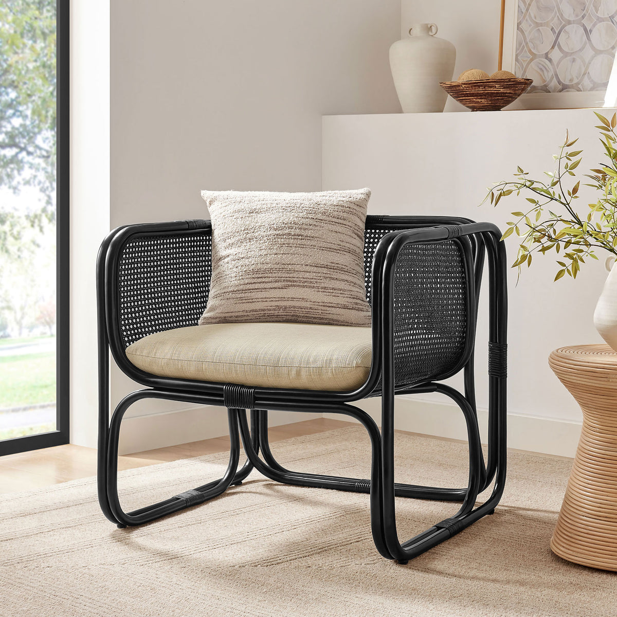 Designed to relax, the black rattan chair brings airy texture and a laid-back vibe to living spaces || EEI-7365-BLK || front_angle_room