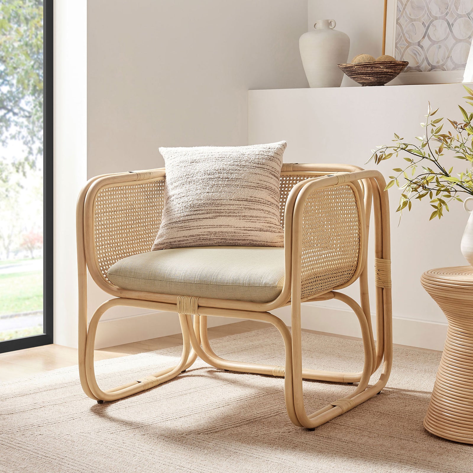 Light natural rattan chair brings relaxed warmth and texture to modern living spaces || EEI-7365-NAT || front_angle_room