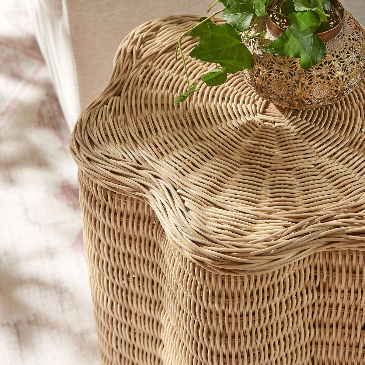 Rattan side table styled with greenery, bringing natural warmth and texture to upholstered seating || EEI-7366-NAT || detail_room