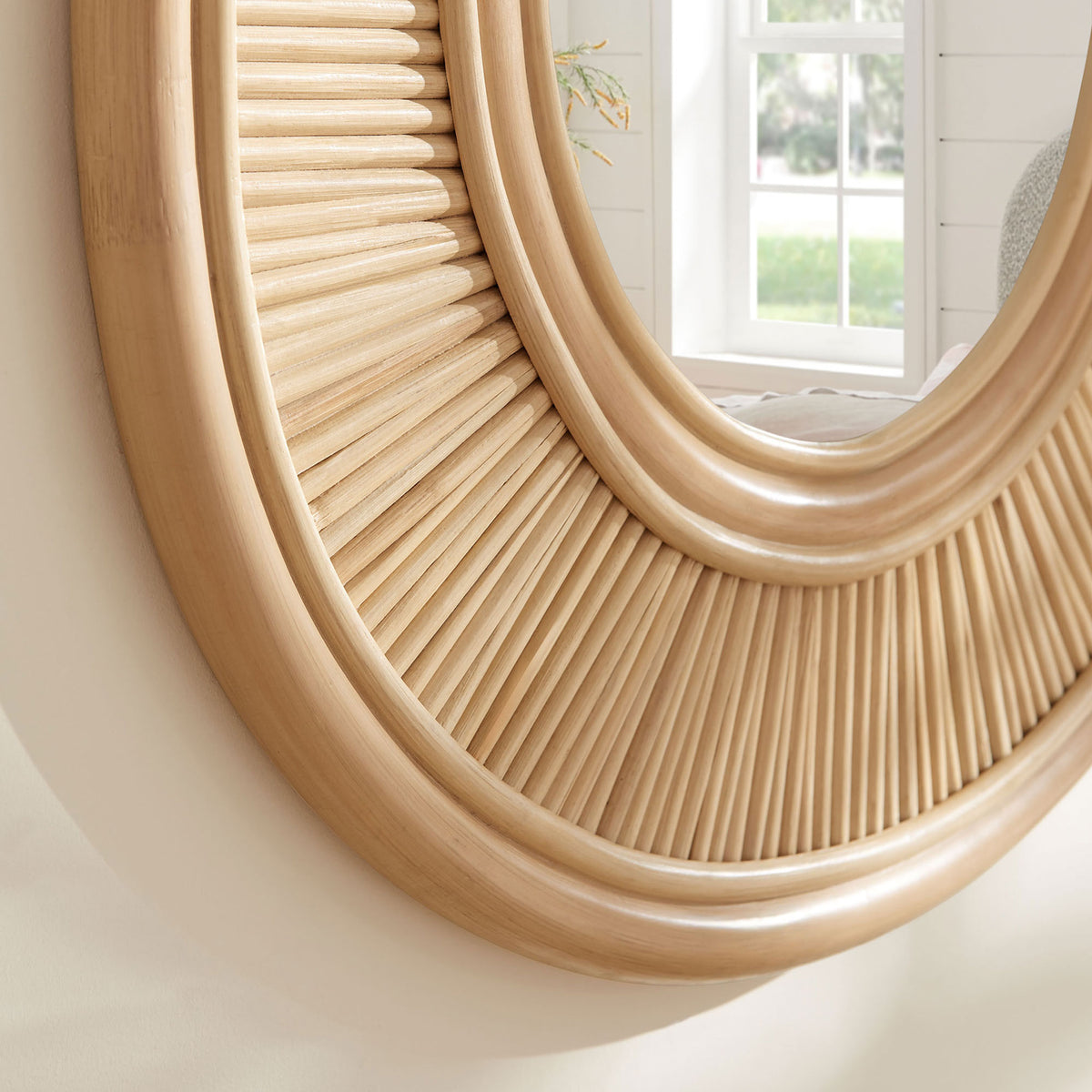 Natural rattan frame catching warm light and reflecting a bright window for a relaxed, airy coastal feel || EEI-7369-NAT || detail_room