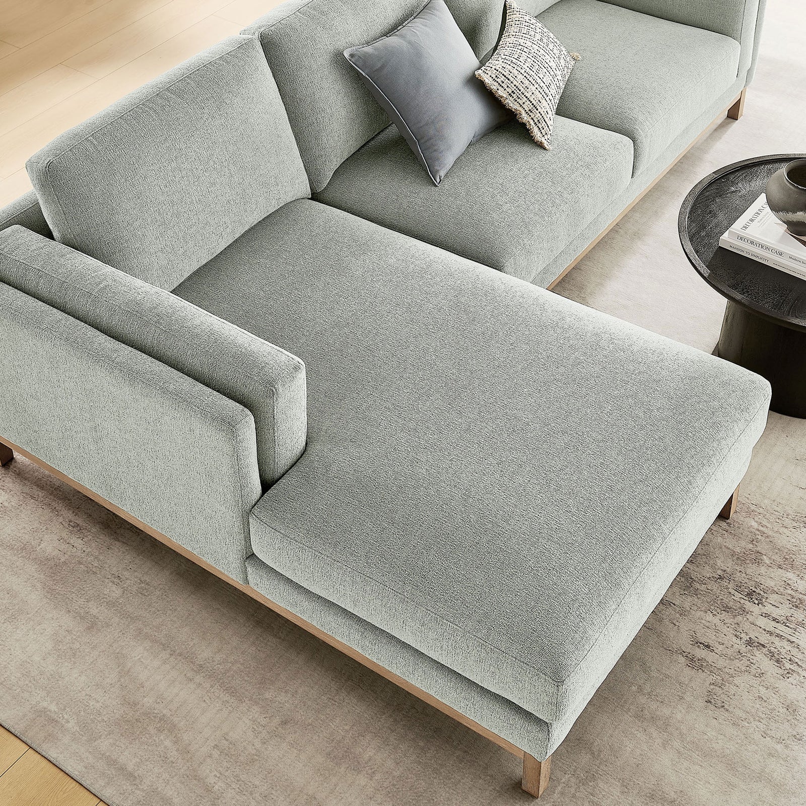 Mist chenille chaise sectional styled with accent pillows and a modern round coffee table || EEI-7374-MST || detail_room