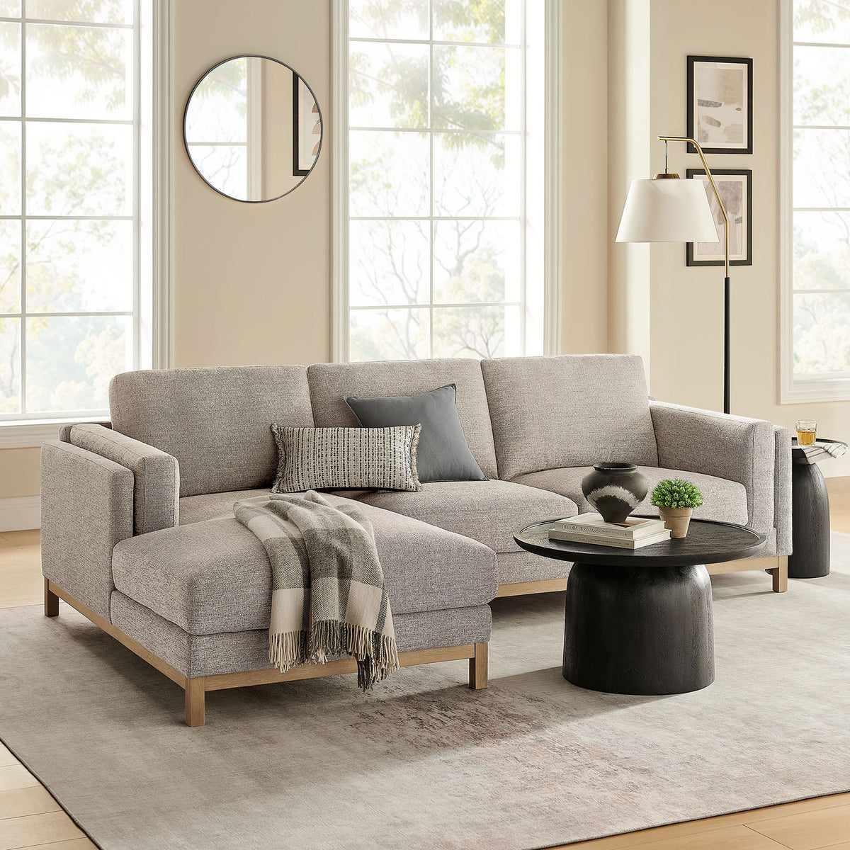Left-facing Roscoe sectional styled in a bright living room with soft rug, round table, and accent decor. || EEI-7374-PEW || front_angle_room