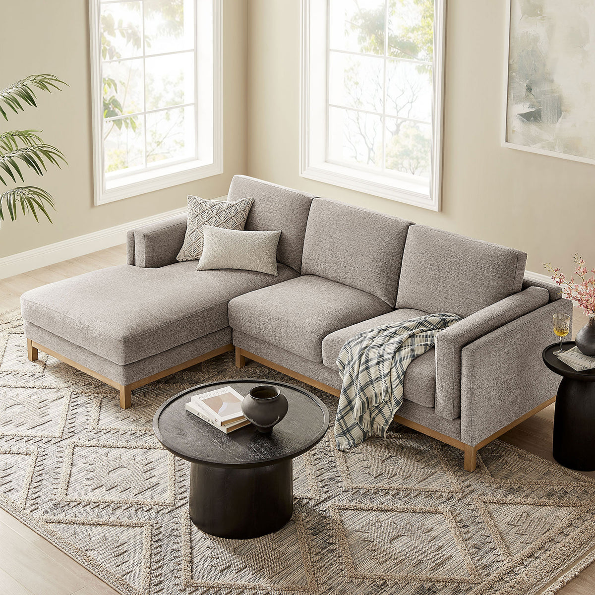 Left-facing pewter sectional arranged on a patterned area rug with layered pillows and cozy throw blanket. || EEI-7374-PEW || front_angle_room