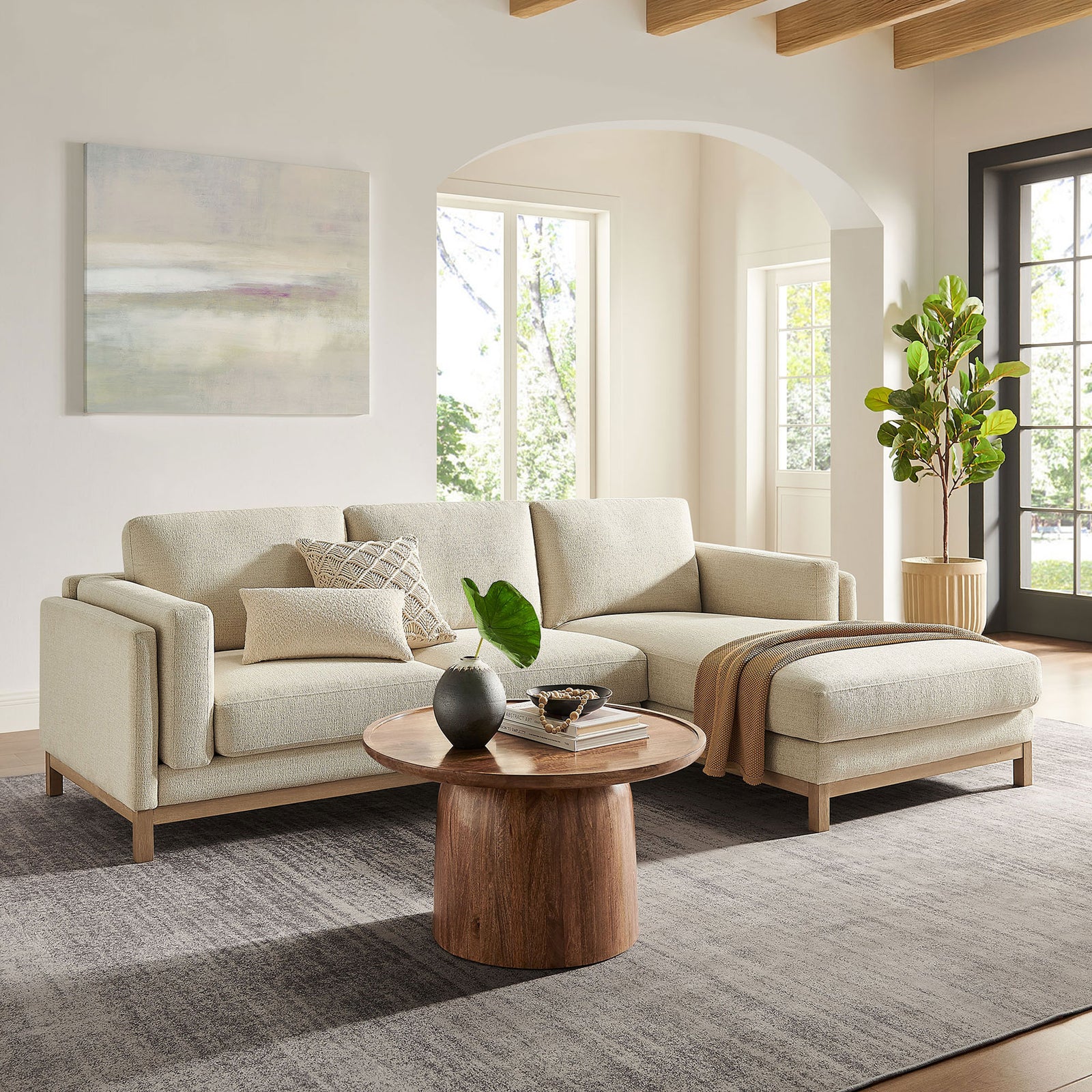 Right-facing ivory sectional in a sunlit living room, styled with a wood coffee table and layered neutral accents || EEI-7375-IVO || front_angle_room