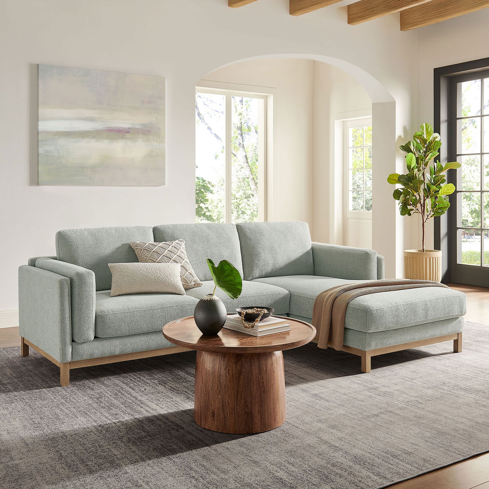 Mist right-facing sectional with chaise styled in a contemporary living room with wood coffee table || EEI-7375-MST || front_angle_room