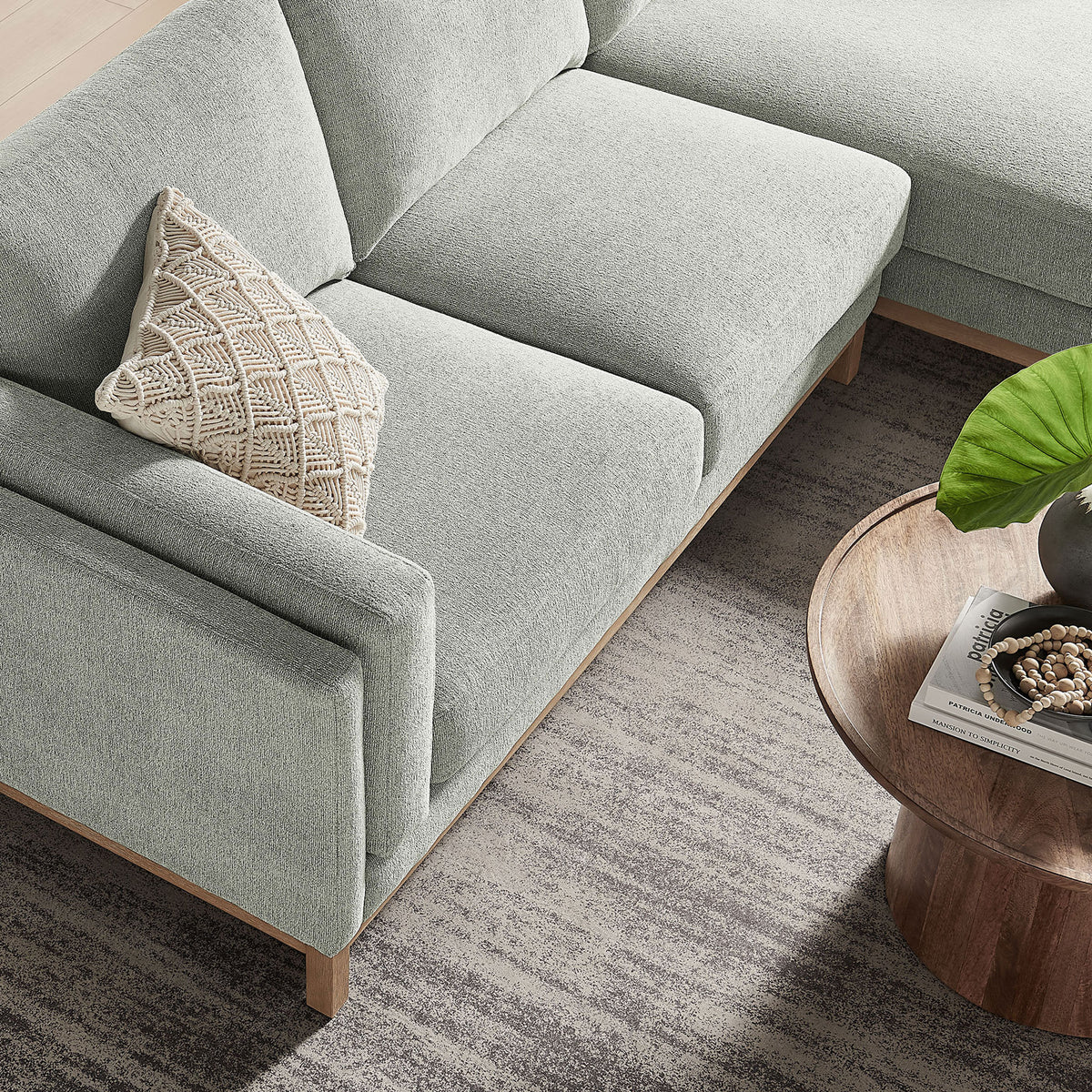 Mist chenille sectional showing tailored seat cushions and slim track arm beside a wood table || EEI-7375-MST || detail_room