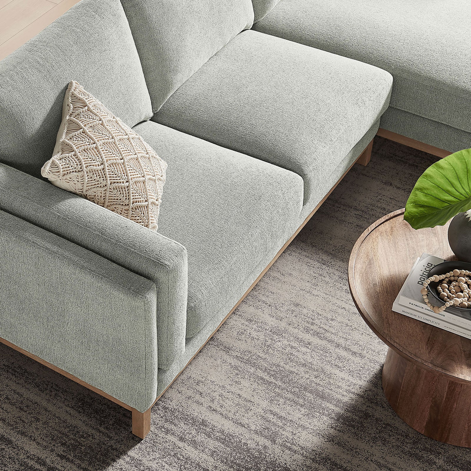 Mist chenille sectional showing tailored seat cushions and slim track arm beside a wood table || EEI-7375-MST || detail_room
