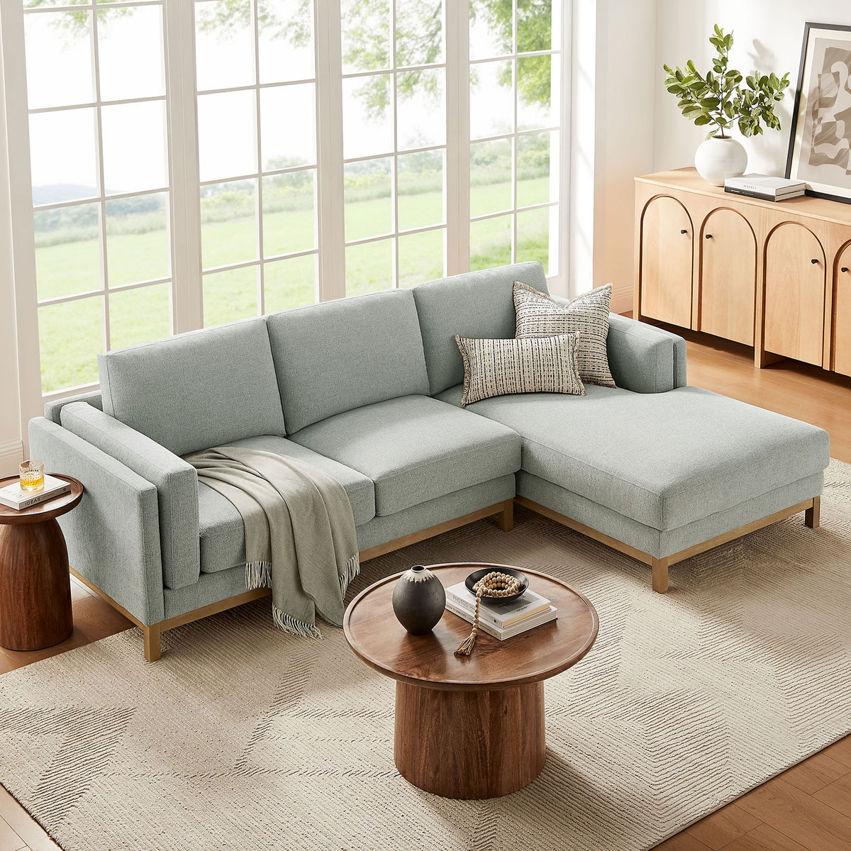 Mist fabric right-facing sectional with chaise arranged in a bright living room with neutral decor || EEI-7375-MST || front_angle_room