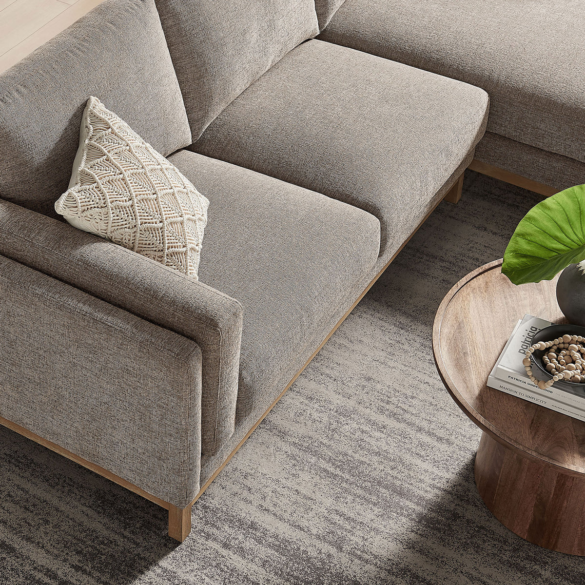 Seat cushions of the Roscoe sectional showing soft chenille upholstery and the sleek wood base edge. || EEI-7375-PEW || detail_room