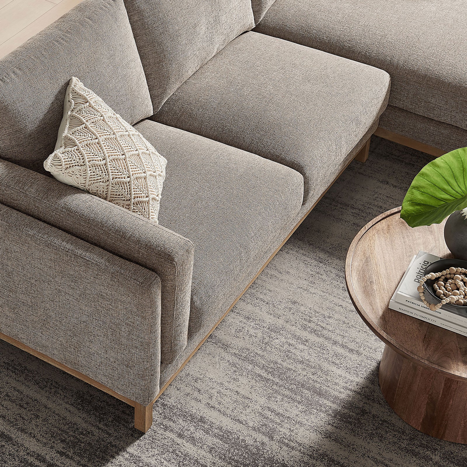 Seat cushions of the Roscoe sectional showing soft chenille upholstery and the sleek wood base edge. || EEI-7375-PEW || detail_room