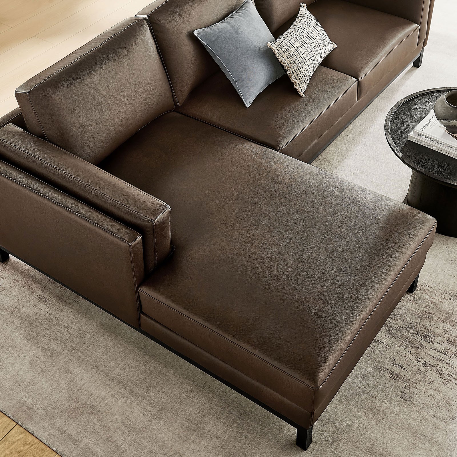Chaise end of the Roscoe left-facing sectional with smooth espresso vegan leather and pillows || EEI-7376-ESP || detail_room