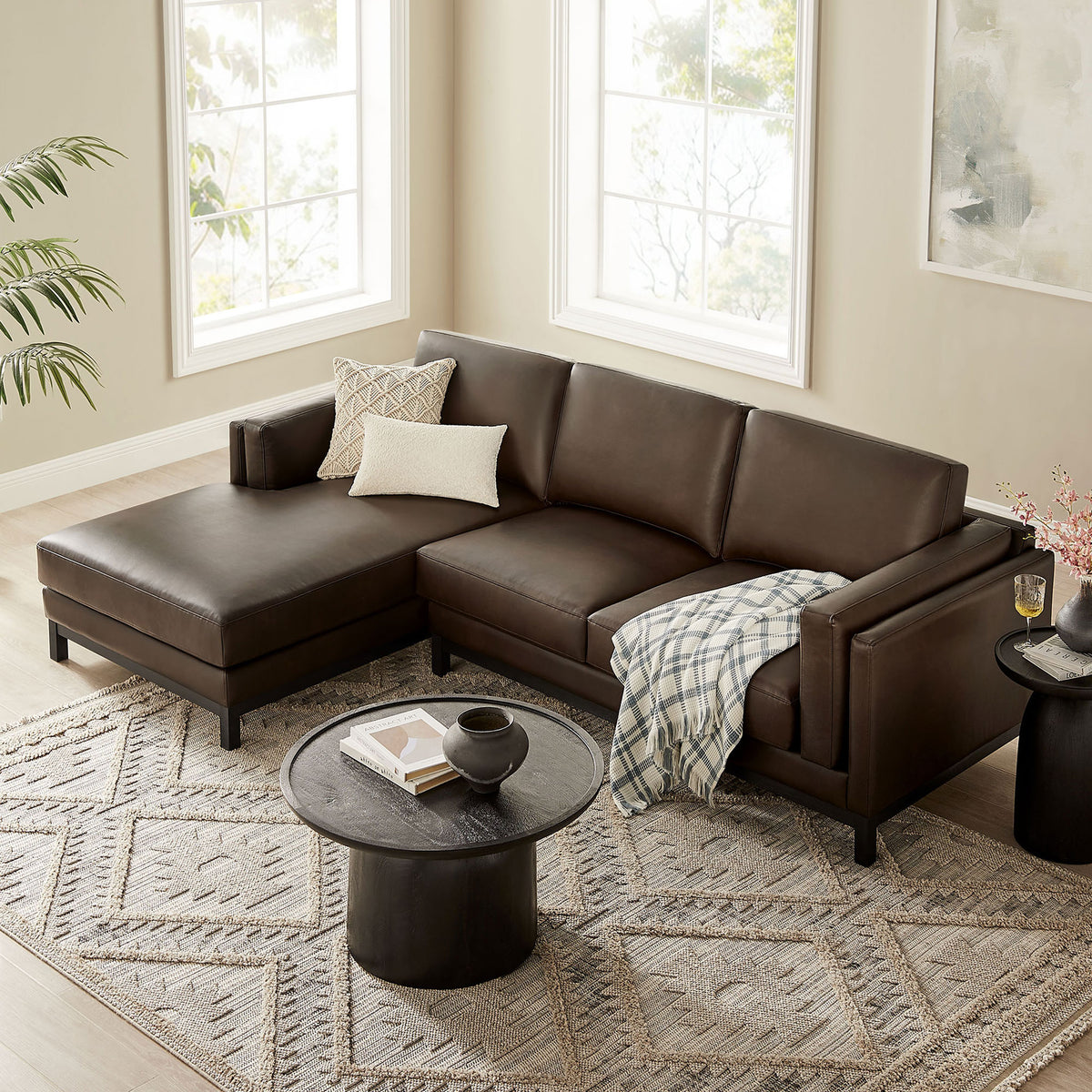 Roscoe left-facing espresso sectional anchored on a patterned rug with cozy throws and pillows || EEI-7376-ESP || front_angle_room
