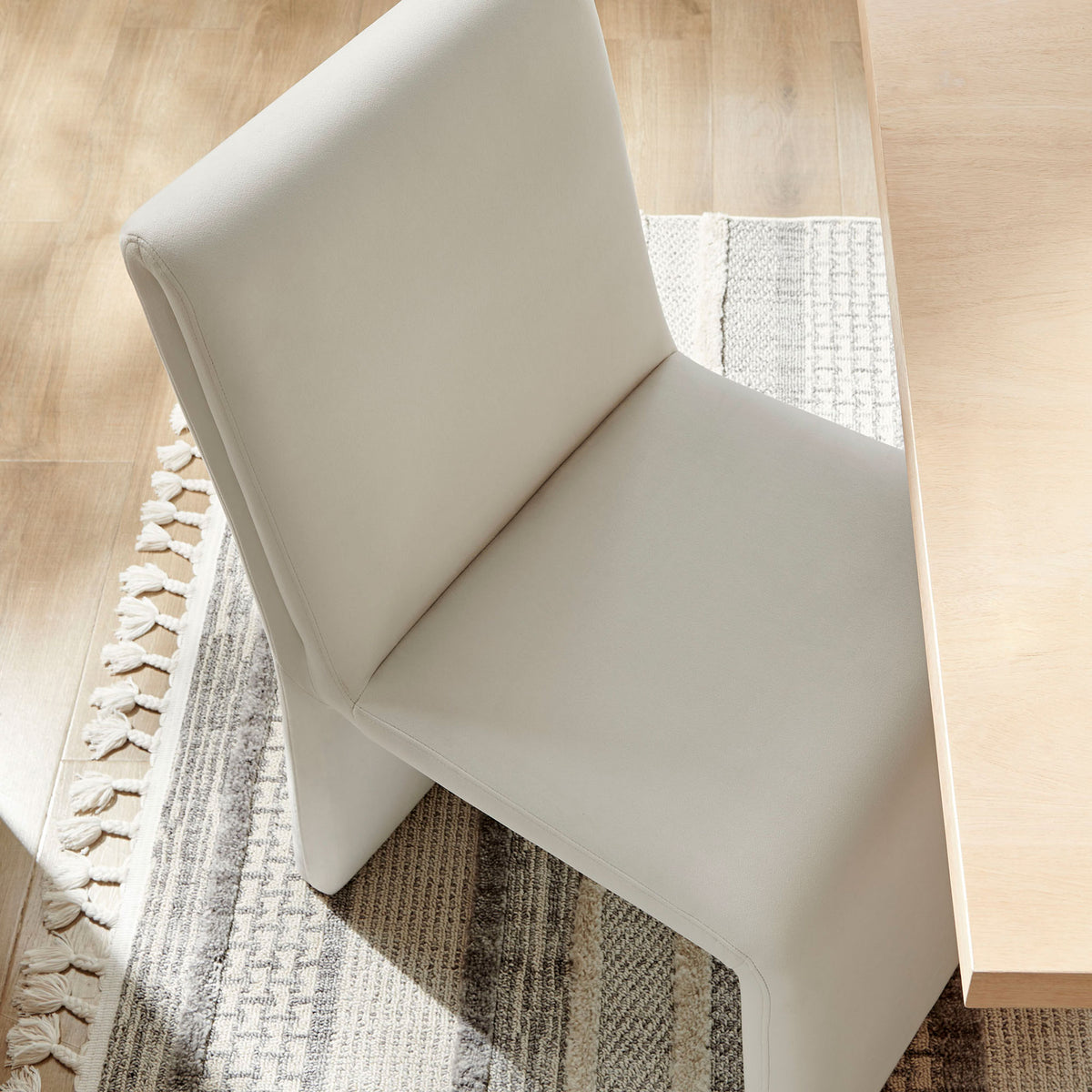 Alabaster performance velvet dining chair softens a modern dining space with inviting texture and gentle curves || EEI-7384-ALA || top_angle_room