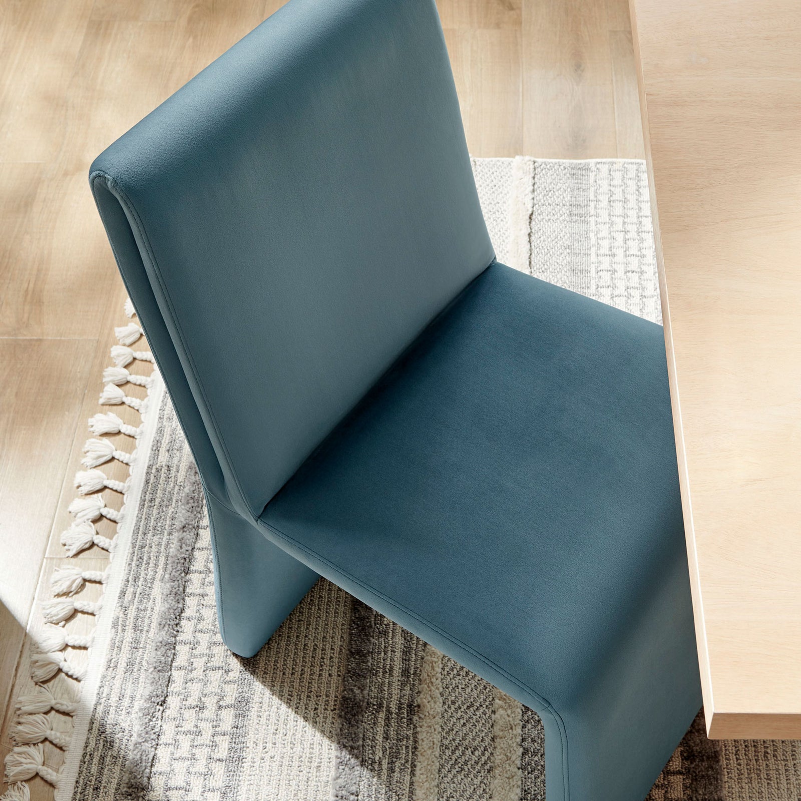 Cadet blue Emory dining chair tucks neatly at the table, adding soft curves and color to the room || EEI-7384-CAB || front_angle_room