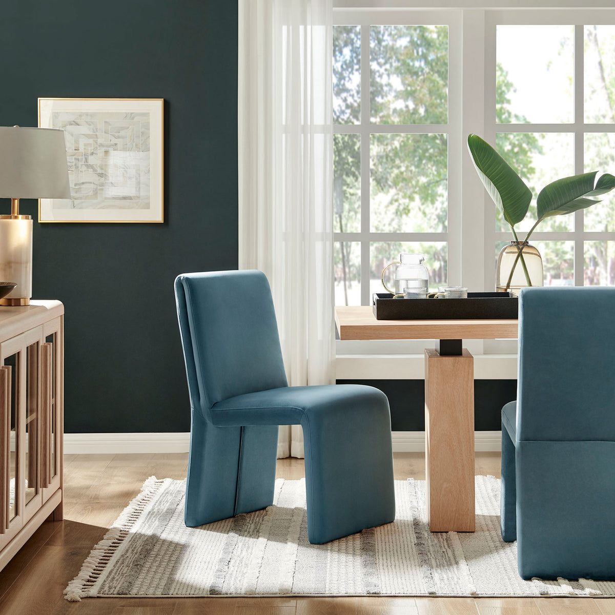 Pair of cadet blue Emory chairs creates a cozy modern dining nook with soft texture and inviting comfort || EEI-7384-CAB || front_angle_room