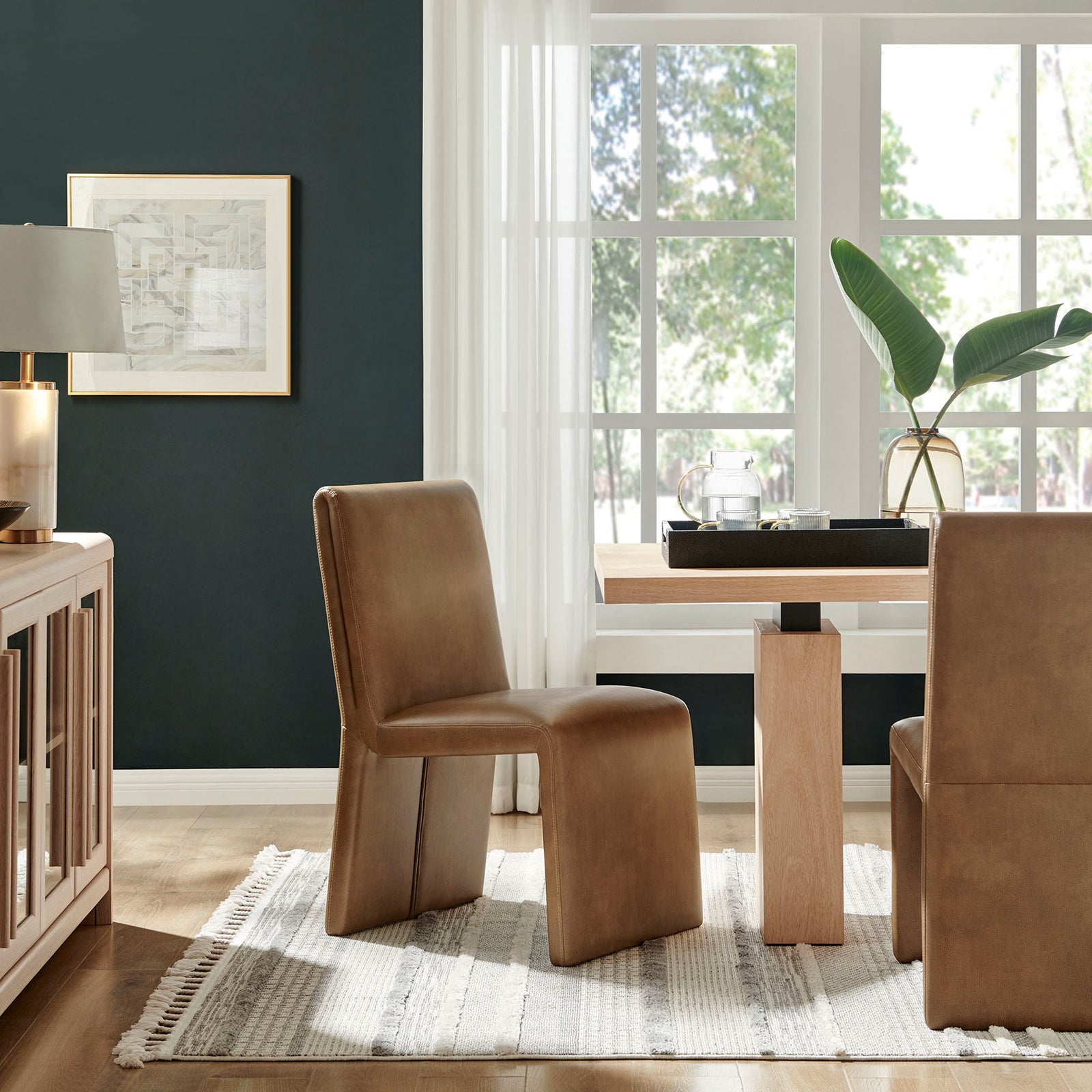 Canyon vegan leather dining chairs create a cozy modern dining space with light wood furniture and a soft rug || EEI-7385-CYN || front_angle_room