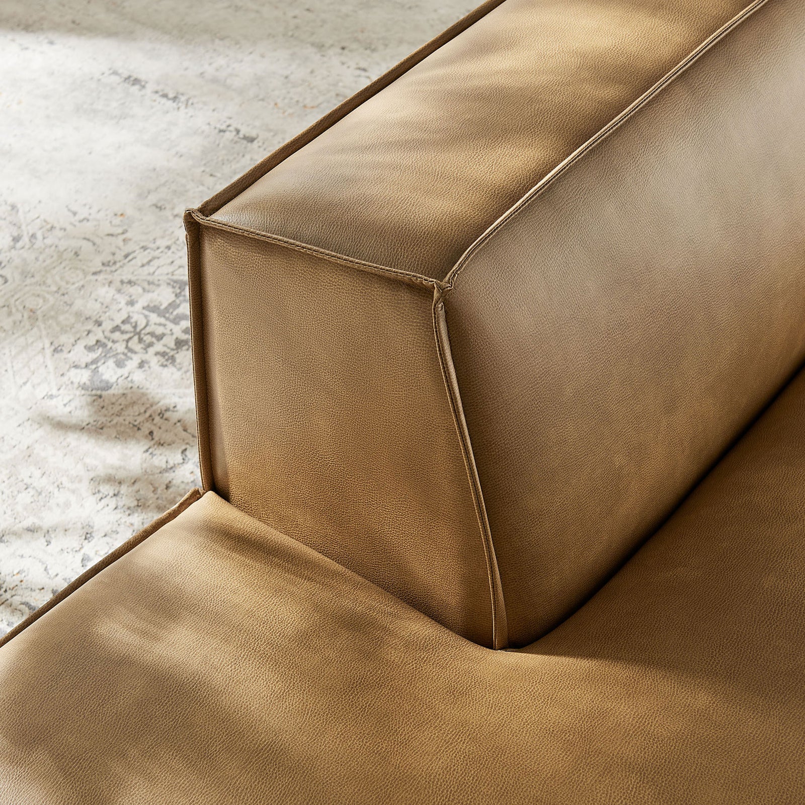 Textured vegan leather and piping details add rich depth to the left-facing chaise || EEI-7387-TST || detail_room