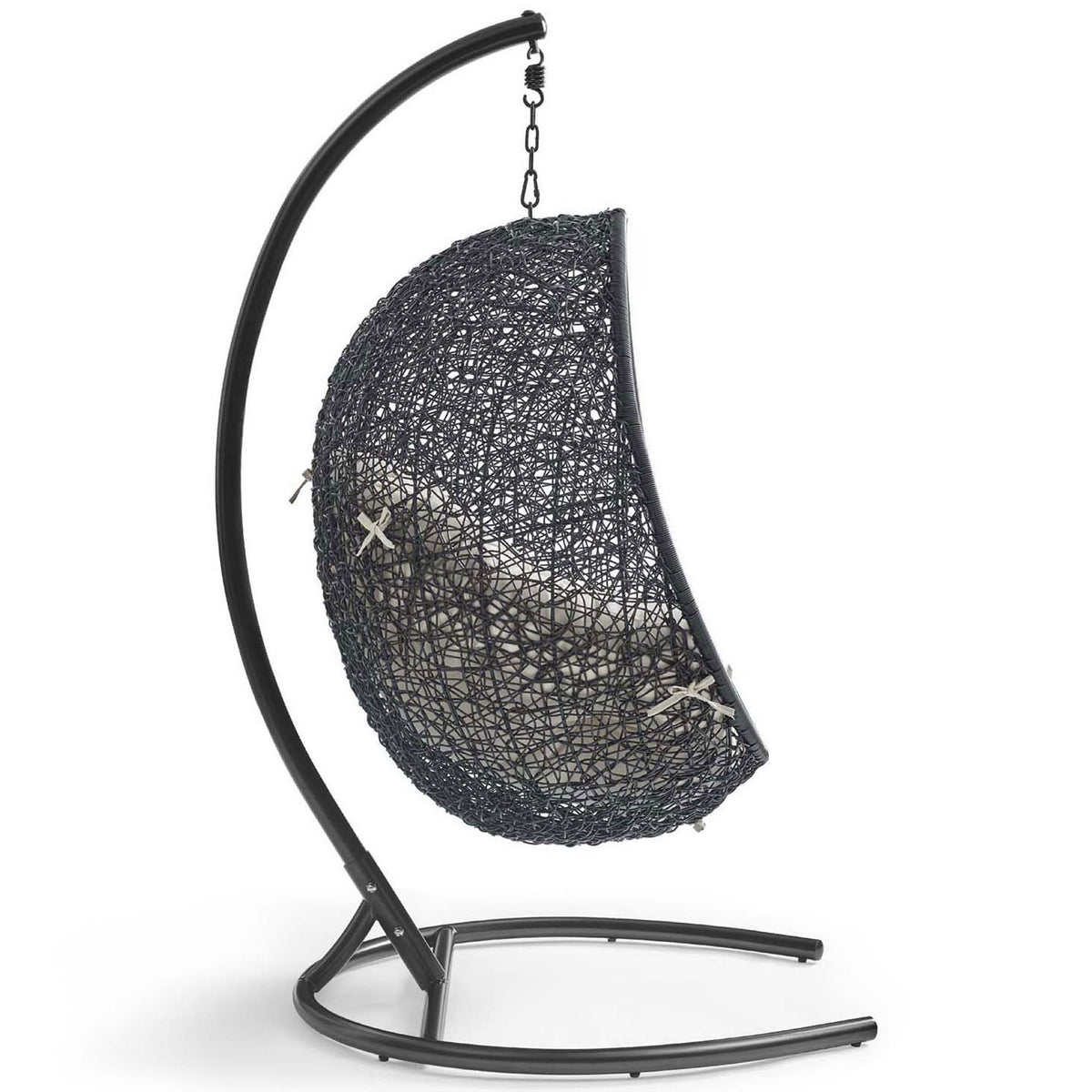 Curved steel base gracefully suspends the woven beige cushion swing chair for outdoor relaxation || EEI-739-BEI-SET || side_studio