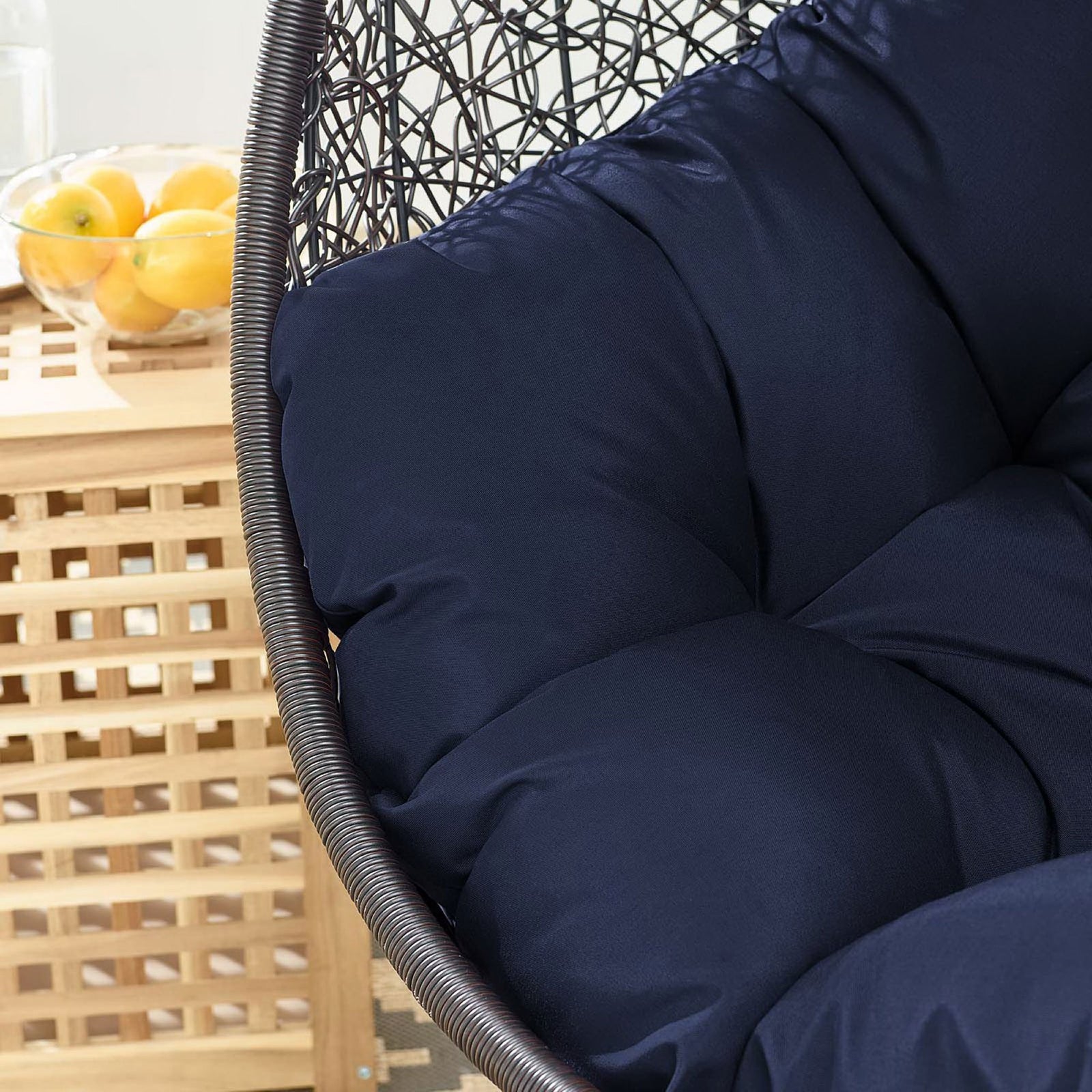 Navy cushion contrasts with natural wood side table and patterned rug on the sunlit deck || EEI-739-NAV-SET || swatch_room