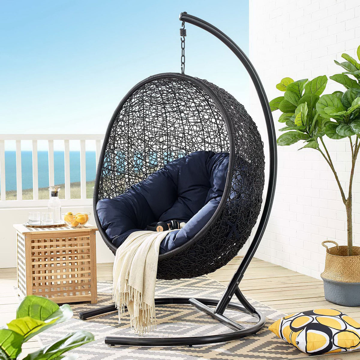 Navy cushioned egg chair with stand creates a dramatic statement piece on the oceanfront patio || EEI-739-NAV-SET || front_angle_room