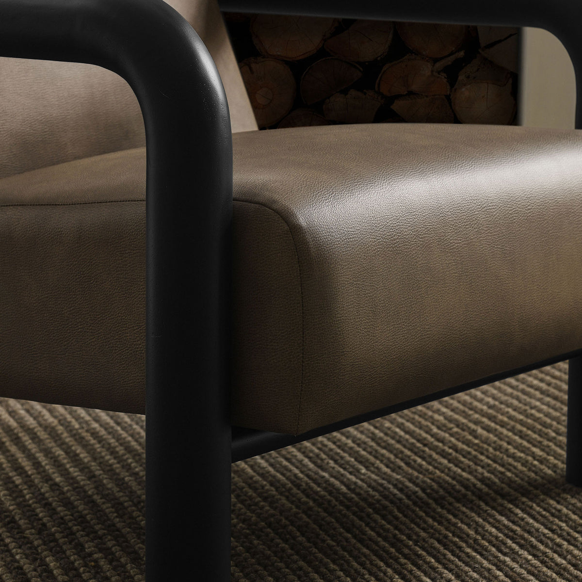 Soft, pebbled upholstery and supportive cushioning invite lingering in any modern space. || EEI-7392-MUS-BLK || detail_room