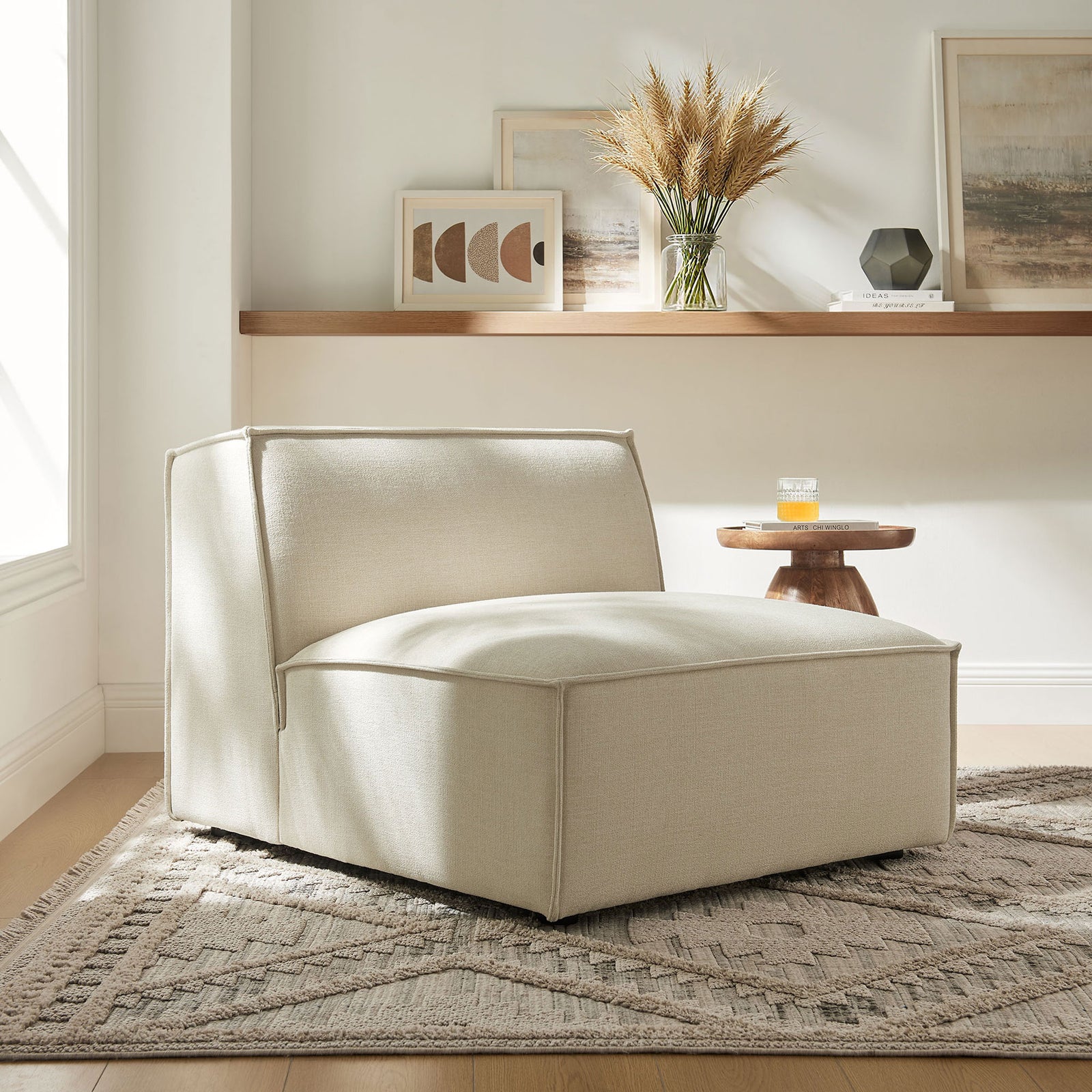 Inviting armless lounge chair delivers plush comfort and crisp lines in a cozy living room || EEI-7395-ECR || front_angle_room