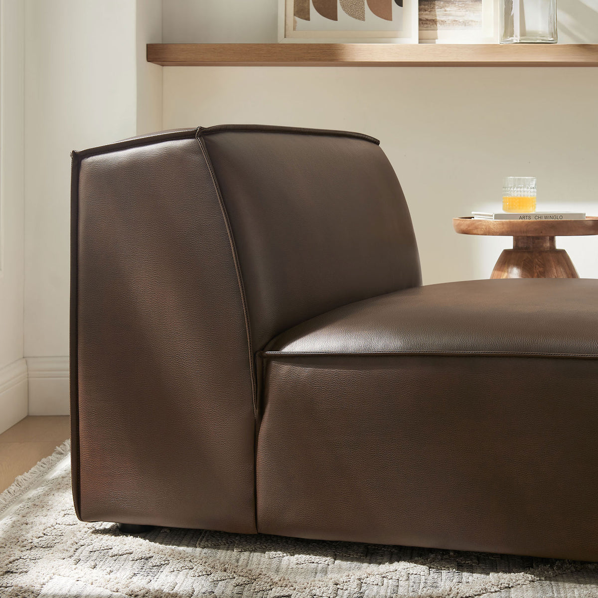 Rich espresso upholstery pairs with cozy textures for an inviting lounge moment || EEI-7396-ESP || detail_room