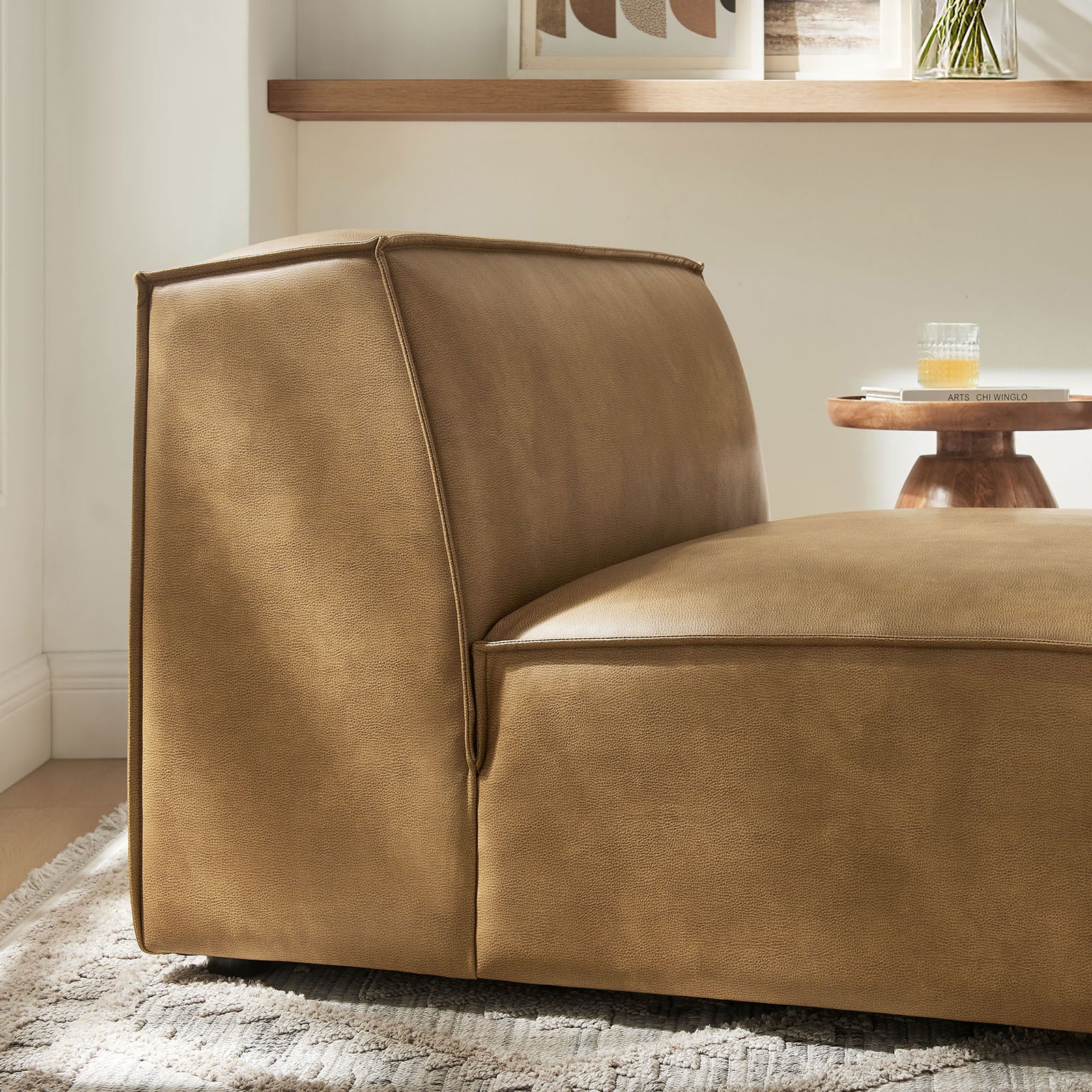 Textured vegan leather and neat piping add inviting warmth to this modular chair. || EEI-7396-TST || detail_room