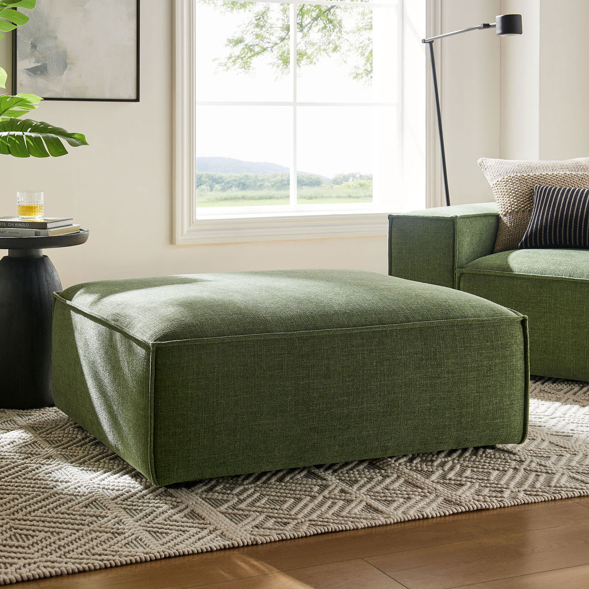 Foliage green modular ottoman anchors a bright living room, pairing with the matching sofa on a soft rug || EEI-7401-FOL || front_angle_room