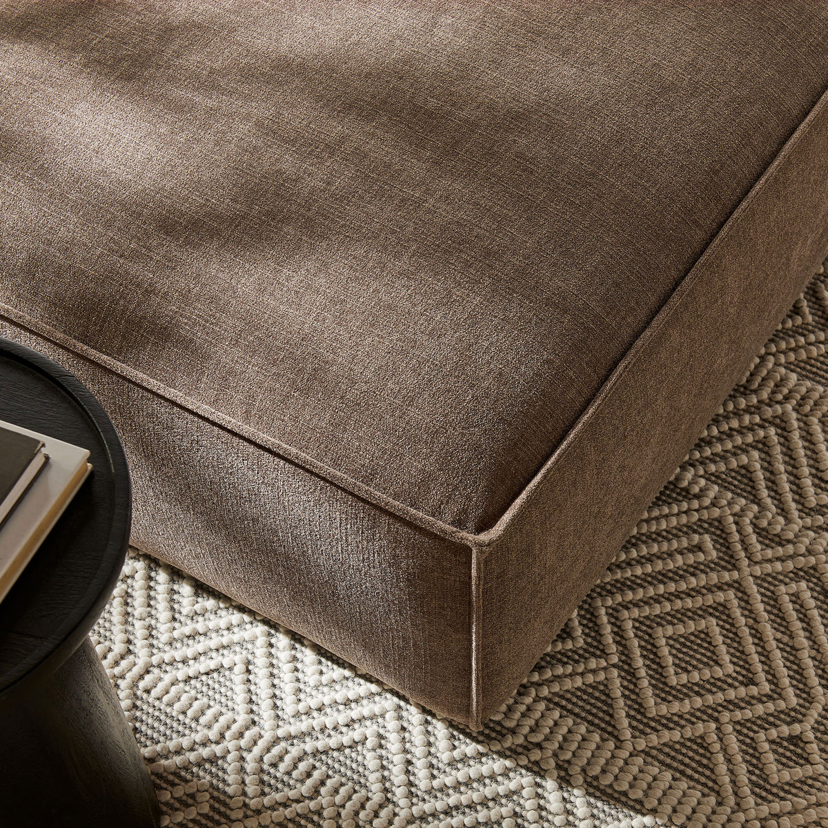 Mocha ottoman styled on a patterned rug, pairing soft performance fabric with simple, contemporary lines || EEI-7401-MOC || detail_room