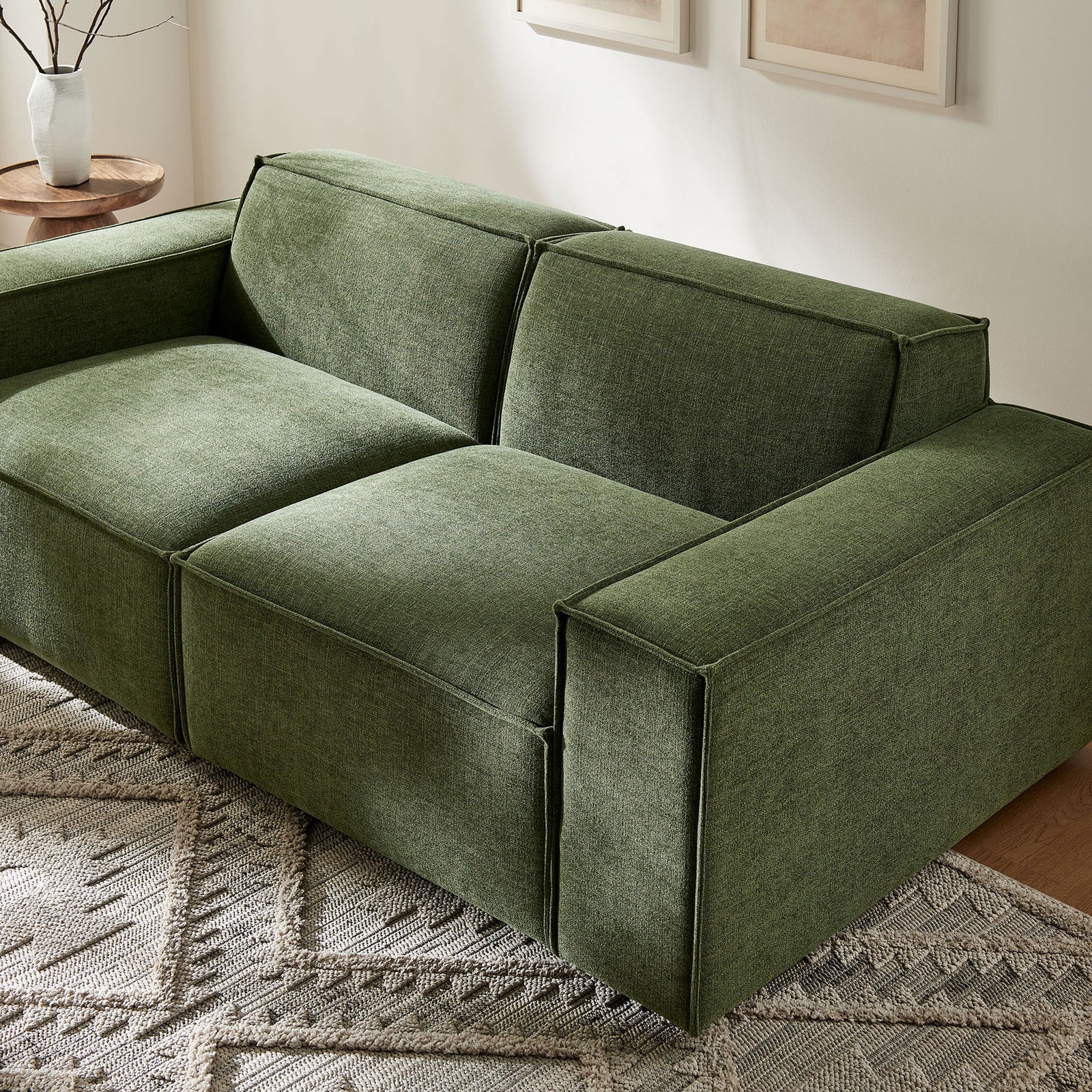 Modern foliage green modular loveseat styled in a bright living room with neutral decor and greenery. || EEI-7403-FOL || front_angle_room
