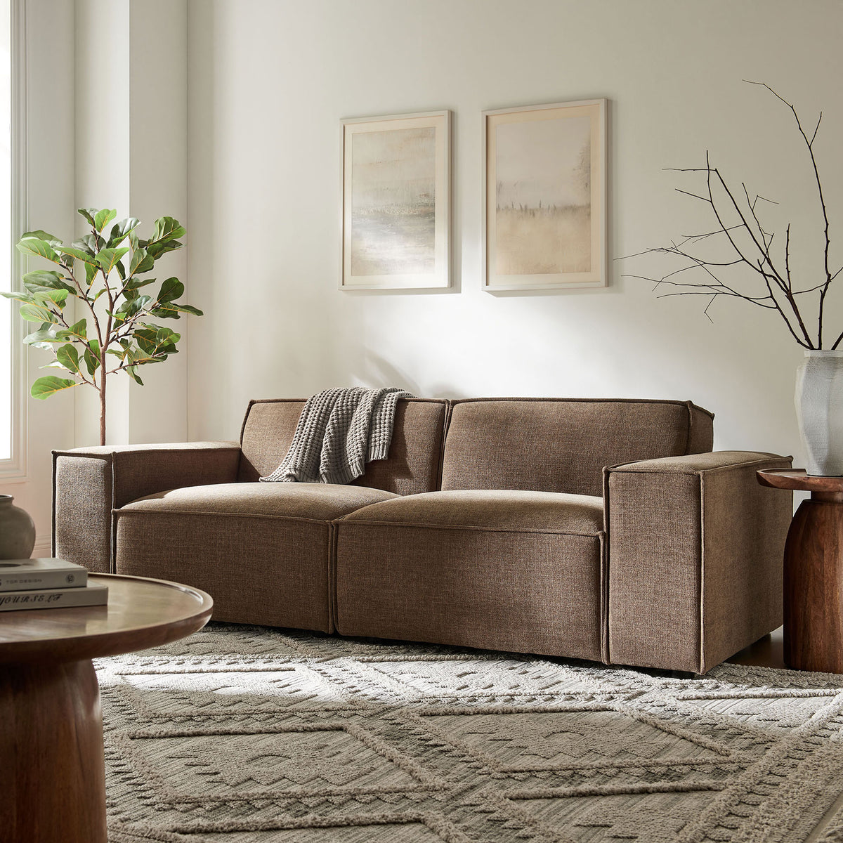 Inviting mocha performance loveseat anchored on a patterned rug with soft artwork and greenery in the background || EEI-7403-MOC || front_room