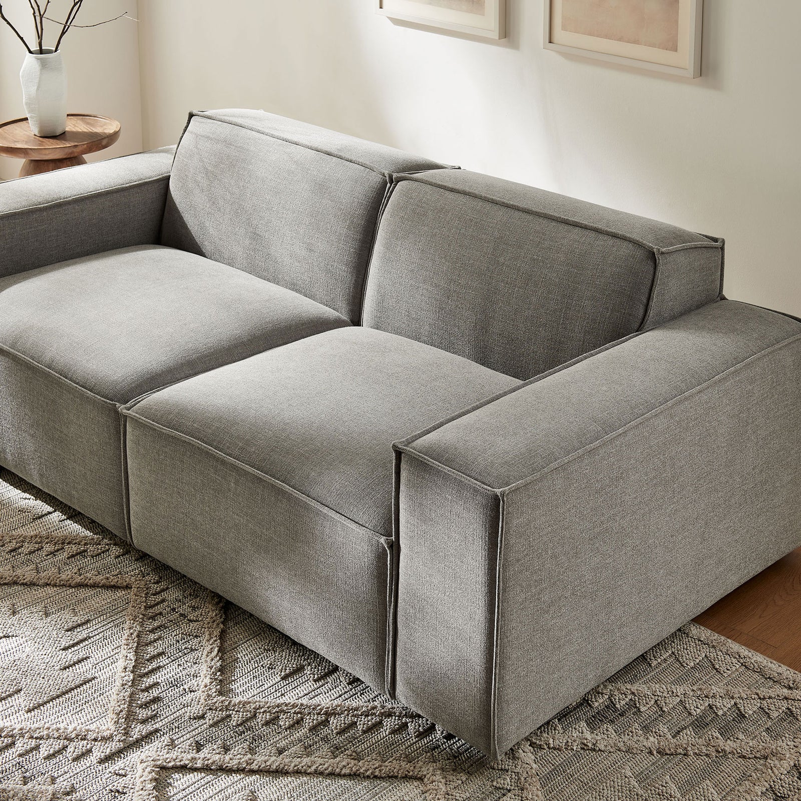 Pewter performance fabric loveseat styled in a modern living room with textured rug and warm wood accents || EEI-7403-PEW || front_angle_room