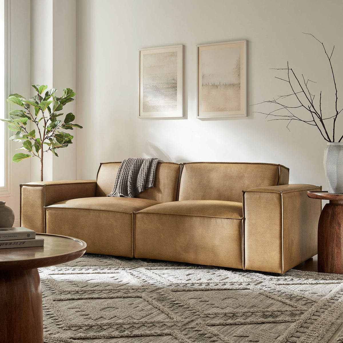 Spacious living room scene featuring the toast vegan leather modular loveseat styled with modern decor. || EEI-7404-TST || front_angle_room