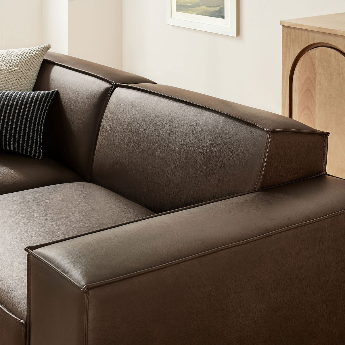 Espresso vegan leather upholstery reveals refined French piping and neatly padded arms for a polished, modern look. || EEI-7406-ESP || detail_room