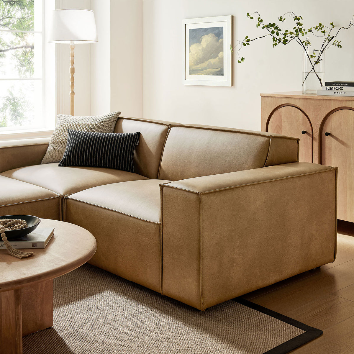 Restore toast vegan leather modular loveseat with ottoman styled in a warm modern living room corner || EEI-7406-TST || detail_room