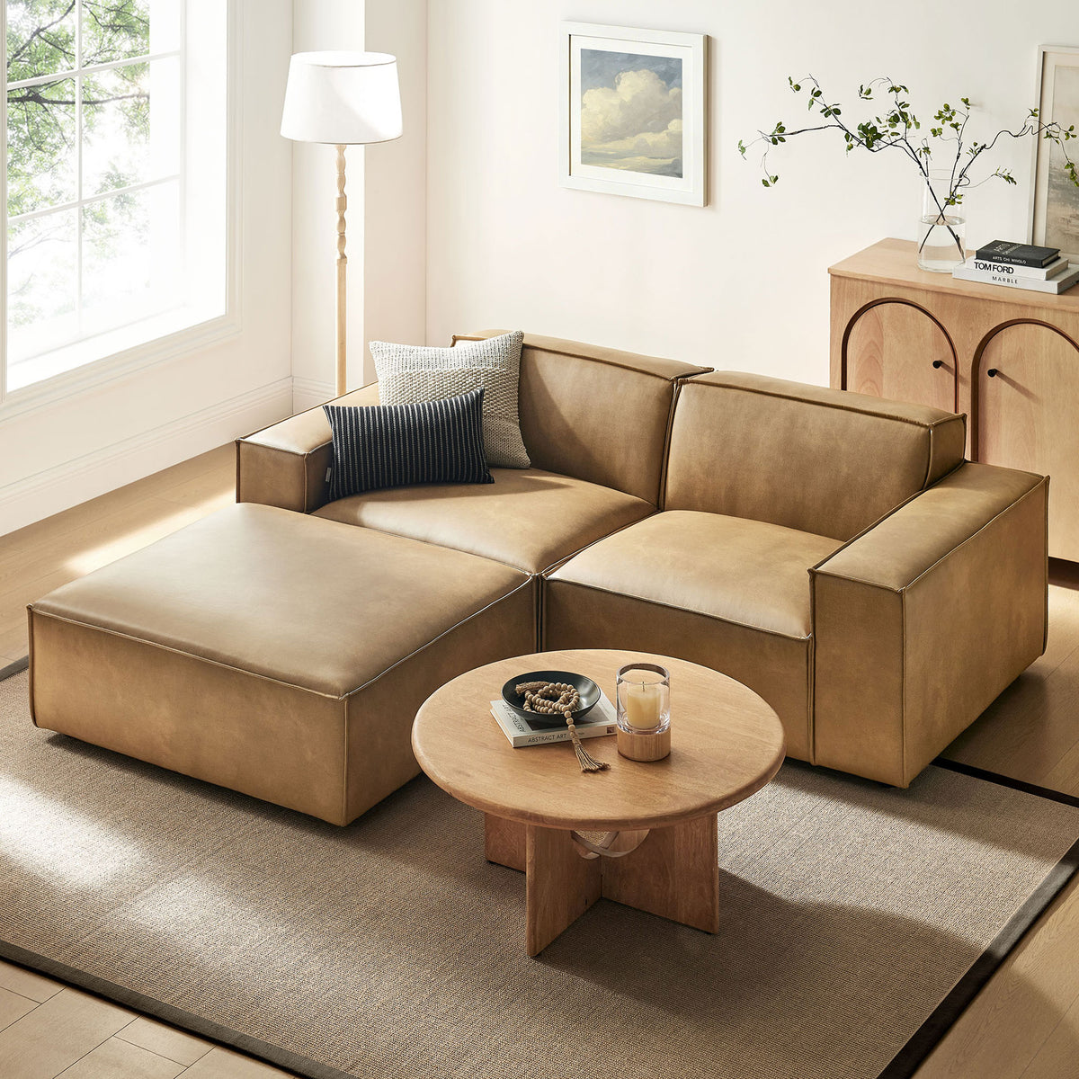 Toast vegan leather modular loveseat with ottoman creating a cozy lounge spot in a sunlit living room || EEI-7406-TST || front_angle_room