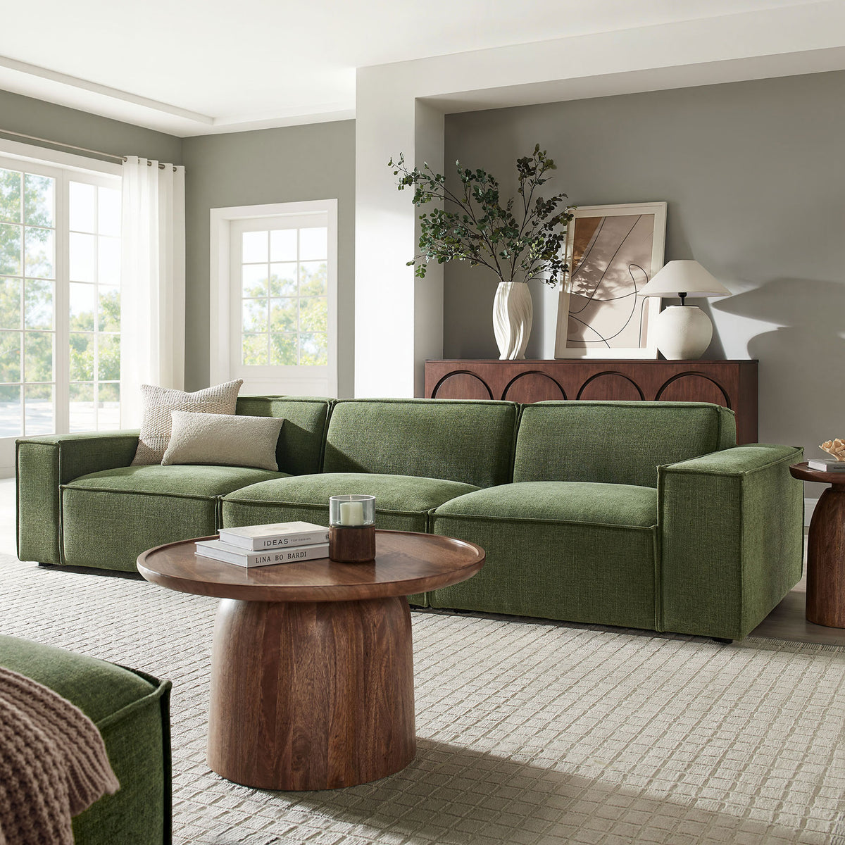Three-piece foliage green sectional arranged in a bright living room with wood coffee table and decor || EEI-7407-FOL || front_angle_room