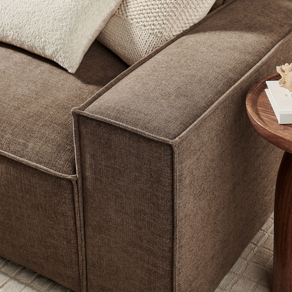 Mocha sofa arm showcasing French piping, generous cushioning, and softly textured performance fabric. || EEI-7407-MOC || detail_room