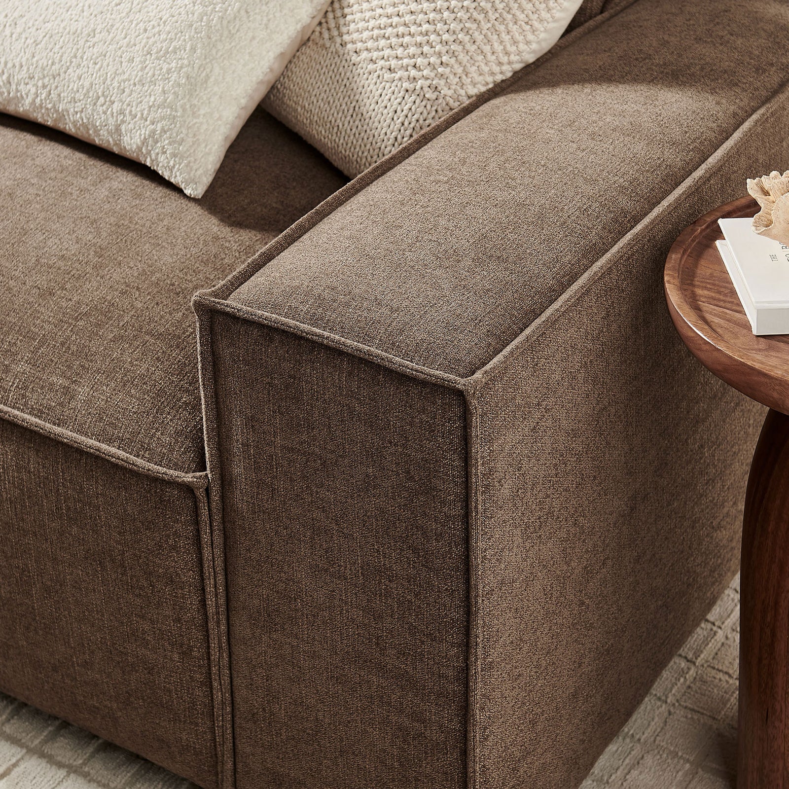 Mocha sofa arm showcasing French piping, generous cushioning, and softly textured performance fabric. || EEI-7407-MOC || detail_room