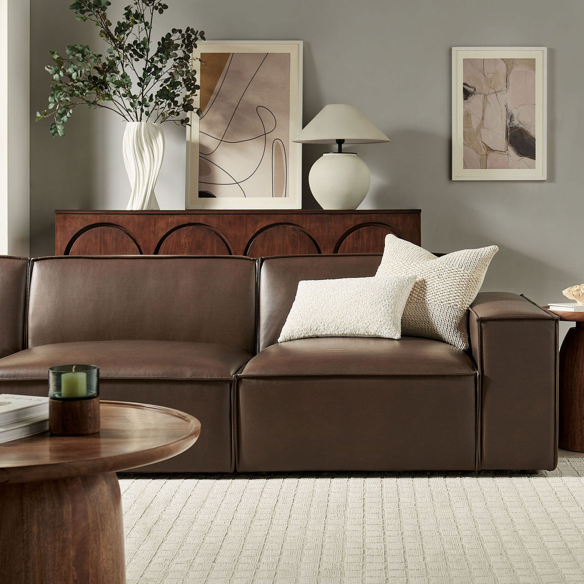Espresso vegan leather modular sofa styled with textured pillows and warm wood accents for a cozy lounge || EEI-7408-ESP || detail_room