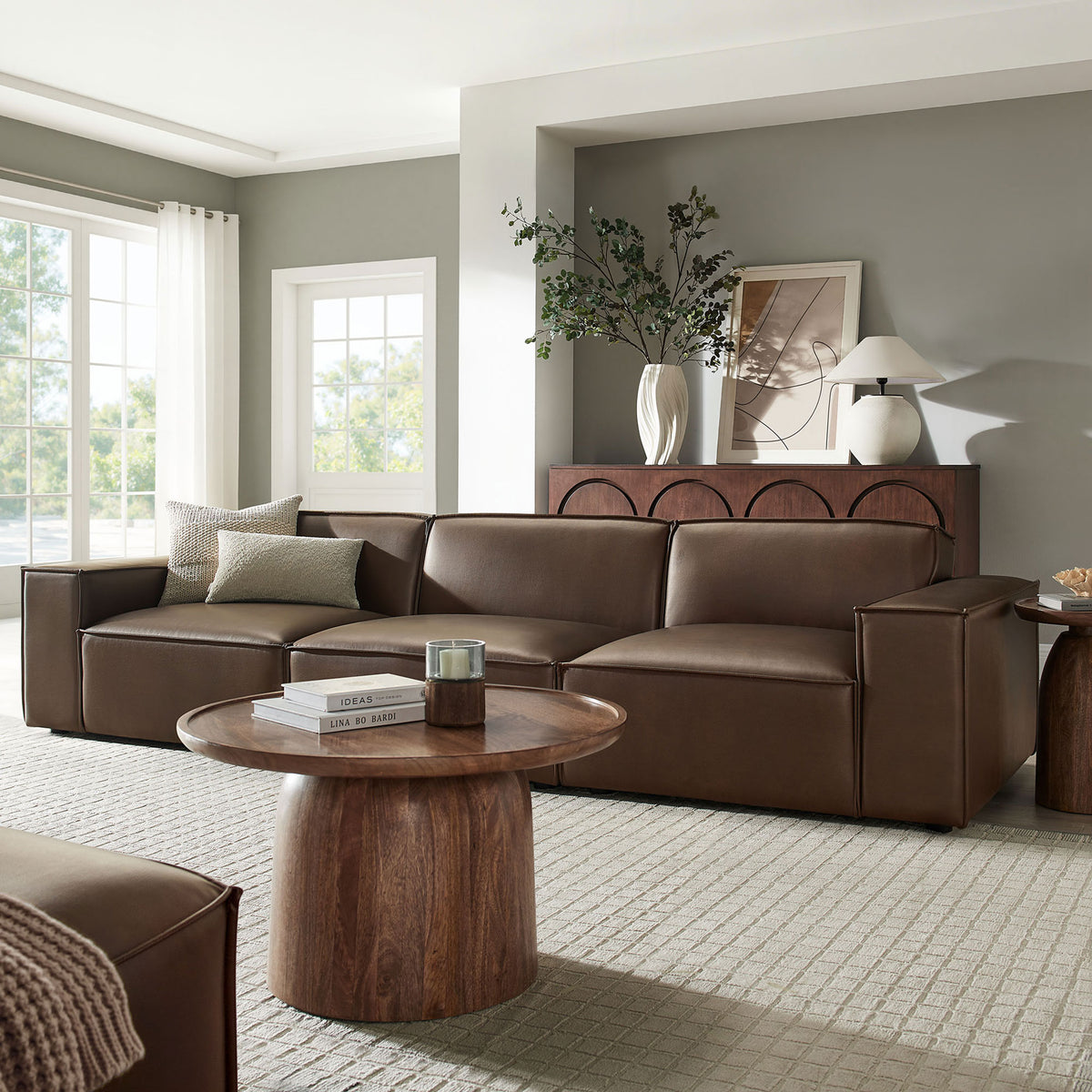 Spacious espresso vegan leather modular sofa anchoring a bright living room with wood coffee table and neutral decor || EEI-7408-ESP || front_angle_room