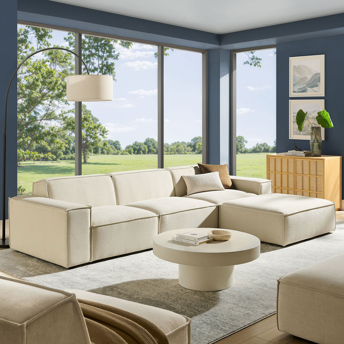 Spacious living room featuring the ecru modular sofa set with ottoman, rug, and modern decor || EEI-7409-ECR || front_angle_room