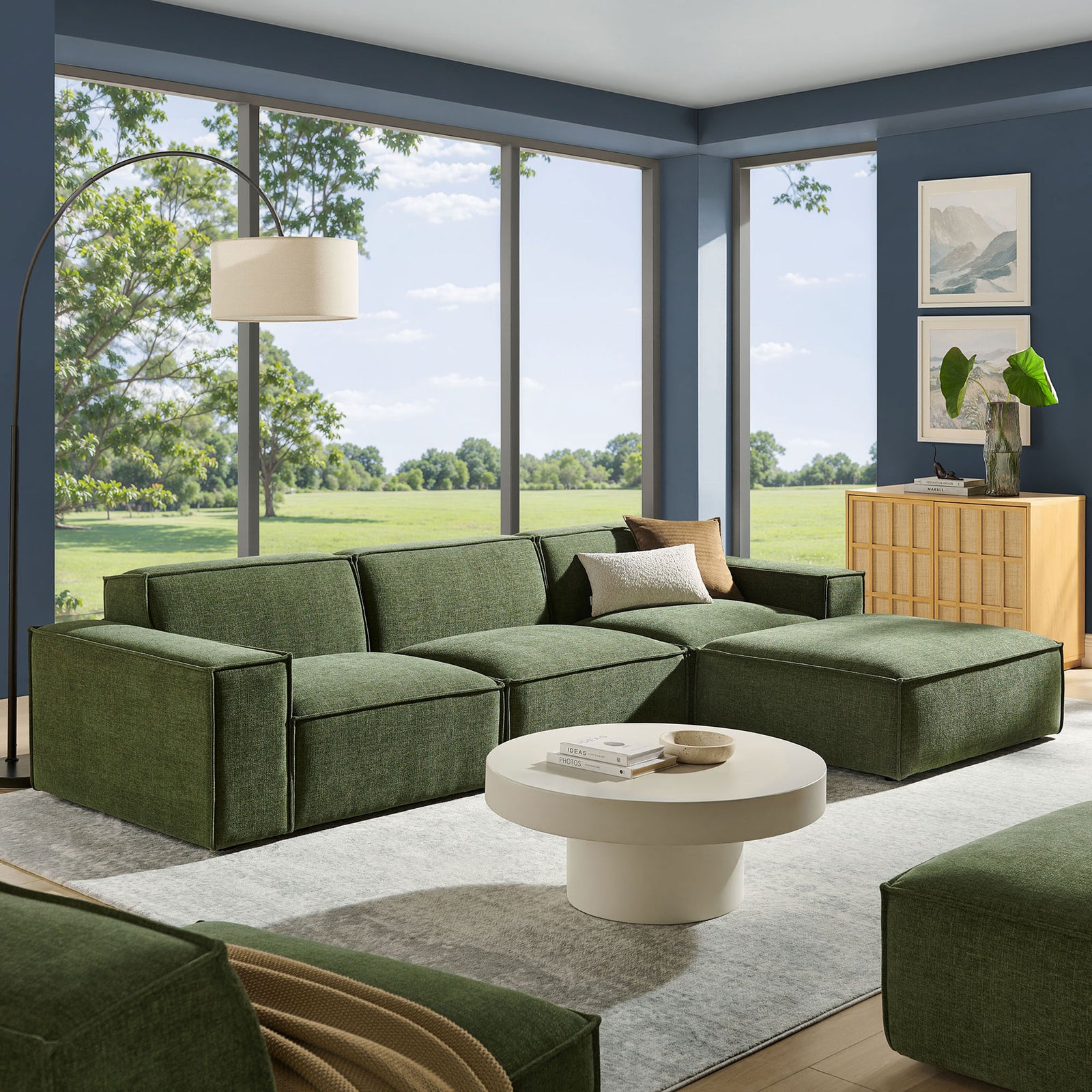 Modern living room featuring the green modular sectional with ottoman and minimalist decor || EEI-7409-FOL || front_angle_room