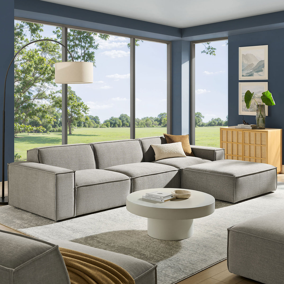 Spacious living room featuring the Restore modular sectional with chaise and ottoman in pewter || EEI-7409-PEW || front_angle_room